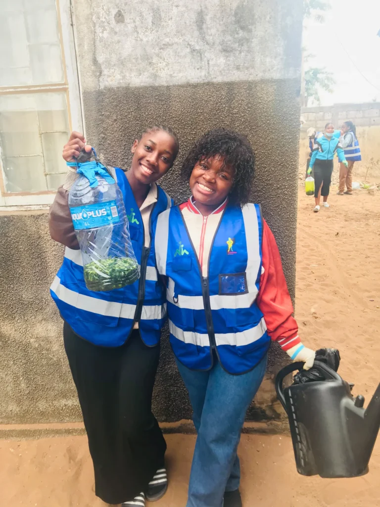 Two smiling volunteers wearing vests