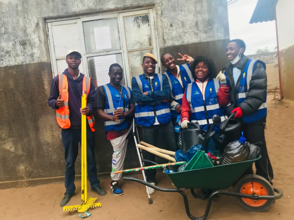 Team of volunteers with vests and wheelbarrows